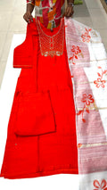 Red traditional outfit with white dupatta featuring floral patterns on a tiled floor.